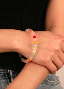 Gros plan d'un bracelet de perles colorées bohème au poignet avec des perles mélangées