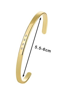 Detailed shot of gold plated C-shaped bangle showing size dimensions 5.5-6cm and zircons