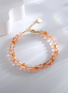 Détail du bracelet en perles colorées avec fermoir mousqueton doré et chaîne réglable