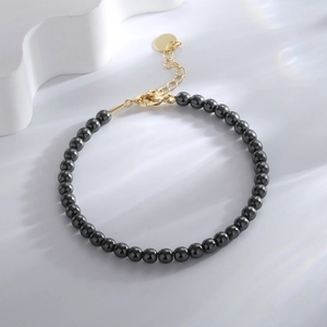 Minimalist dark gray hematite bead bracelet with adjustable golden lobster clasp and charm