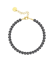 Minimalist black beaded bracelet with gold lobster clasp and extension chain on white background