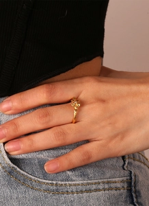 Detailed view of lucky clover ring with zircon inlay and gold plating on hand