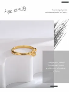 Detail of gold clover ring with zircon and textured bark finish on artist stand