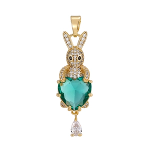 Detail view of a gold rabbit pendant with green heart stone and zircon accents