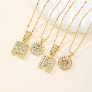Gold plated necklaces with iced out M and H letter pendants featuring zircon pavé settings
