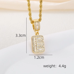 Macro detail of gold plated letter E pendant with cubic zirconia inlay and rope chain