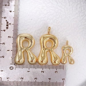 Three sizes of 3D puffy balloon letter R pendants in gold plating with ruler scale
