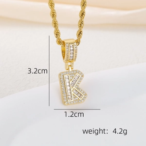 Detailed view of gold plated letter K pendant with baguette cubic zirconia and dimensions