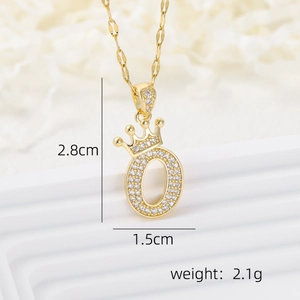 Macro view of crown letter O pendant with cubic zirconia and 18k gold plating