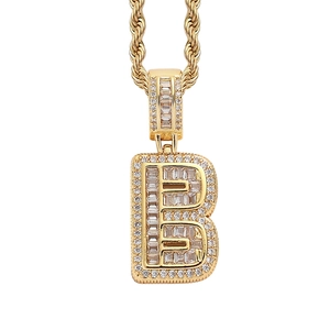 Detail of gold-plated hip-hop letter B pendant with baguette zirconia and twist chain