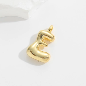 Detail of a 3D bubble letter E pendant with polished gold finish and balloon style design