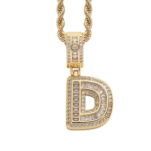 Close-up of gold-plated iced-out letter D pendant with cubic zirconia on rope chain