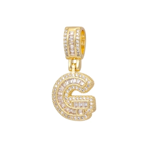 Close-up of 18k gold letter G pendant with baguette and round cubic zirconia stones