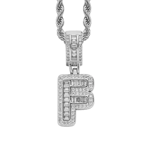 Macro detail of iced-out silver letter F pendant with CZ stones on rope chain