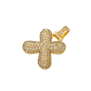 Macro detail of bubble style cross pendant with gold plating and cubic zirconia