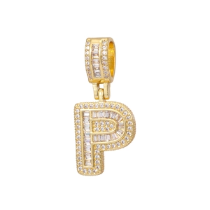 Macro detail of gold-plated P-letter pendant with baguette and round-cut crystals
