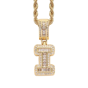 Macro shot of hip-hop letter I pendant in gold with baguette and round cut crystals