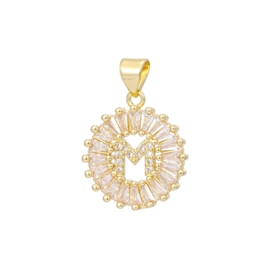 Close-up of 18k gold plated letter M pendant with sparkling baguette zircon stones