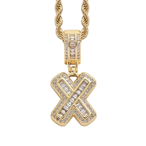 Detail of golden hip-hop letter X pendant with pavé-set rectangular and round zircons