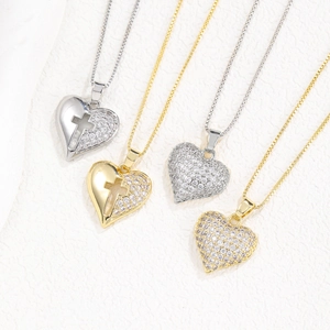 Detailed view of heart and cross pendant necklaces with gold plating and cubic zirconia