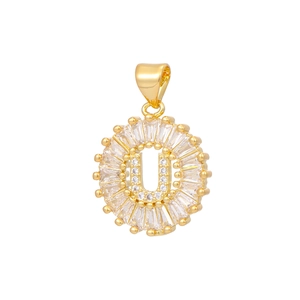 Detail of 18k gold plated letter U pendant with baguette and round cubic zirconia stones