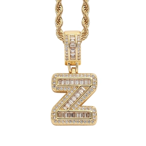 Detailed close-up of iced out gold plated letter Z pendant with sparkling baguette zircons