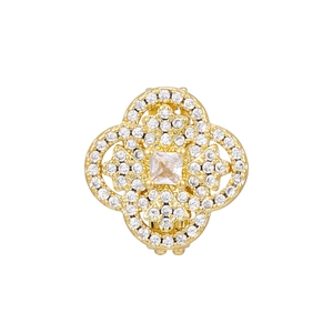 Macro view of gold flower-shaped earring with brilliant zircon stones and hollow carving