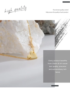 Detailed view of gold plated heart pendant with engraved letter R on brass chain