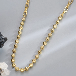 Golden bead and paperclip link splice necklace with a polished finish and minimalist design