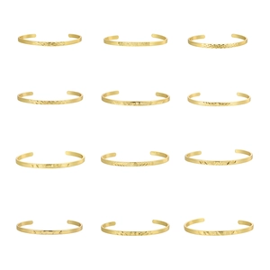 Set of 12 minimalist golden cuff bracelets with diverse geometric engraved patterns