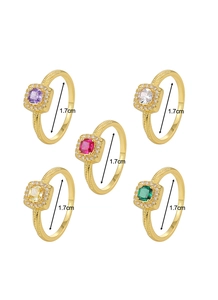 Detail view of five square cubic zirconia rings in gold finish with 1.7cm inner diameter