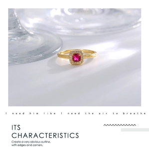Detailed view of a vintage gold-plated ring with square red zircon and white stones