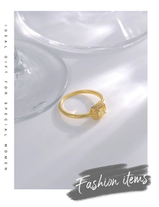 Macro shot of gold-plated ring with yellow square zircon and beaded vintage texture