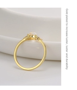 Detailed view of a gold-plated vintage ring featuring a translucent gem and zircon accents