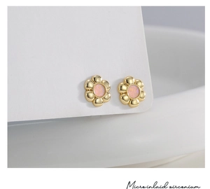 Detail of 18K gold flower studs with pink opal-like inlay and micro-set zircon