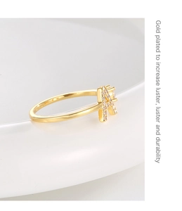 Macro shot of 18K gold plated ring featuring a crystal-encrusted letter A on ceramic