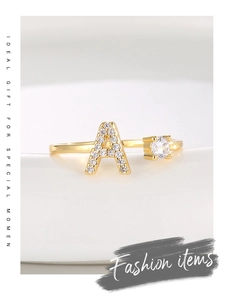 Detailed macro of an 18K gold letter A ring featuring micro-set cubic zirconia stones
