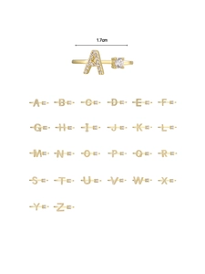 Macro detail of 18K gold plated A-Z letter rings with cubic zirconia inlay 1.7cm width