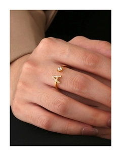 Close-up of 18K gold plated ring with letter A zircon inlay and round center stone