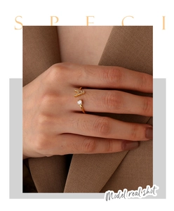 Detailed view of 18K gold ring with crystal letter A and round sparkling zircon stone