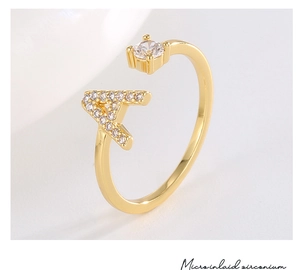 Detailed macro view of 18K gold plated ring with micro-inlaid zircon and letter A