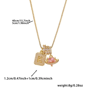 Detail of 40cm gold chain necklace featuring cubic zirconia K letter and pink heart planet