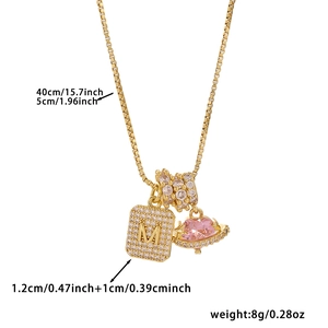 Detail showing dimensions of gold M letter pendant with pink heart and box chain