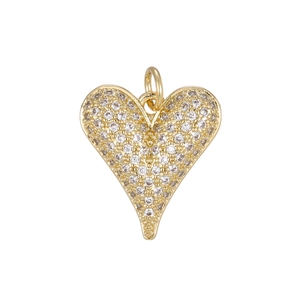 Macro shot of 18K gold heart pendant with shimmering pavé set cubic zirconia stones