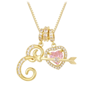 Detail of 18K gold cupid's arrow necklace with pink heart stone and crystal inlay