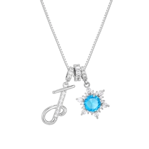 Detailed macro of letter T pendant and blue snowflake charm on silver chain