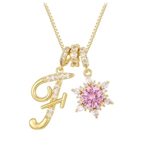 Golden necklace featuring a pink cubic zirconia snowflake and crystal letter F pendant