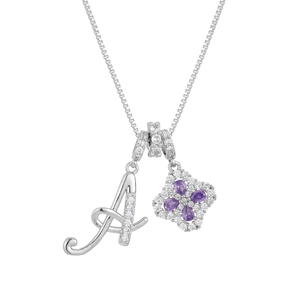 Macro detail of silver necklace with diamond letter A and purple four-leaf clover pendant