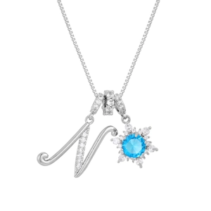Detailed close-up of cursive letter N pendant with blue stone snowflake on silver chain