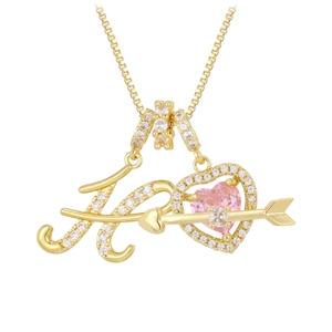 Detail of gold necklace with letter K heart pendant and pink gemstone heart stone